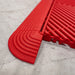 A close up of a Ribtrax Pro Racing Red Corner connected to a tile and ramp section