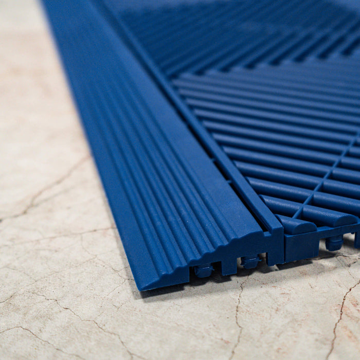 A side on close up of connecting Royal Blue Swisstrax tiles and ramps