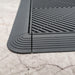 A closeup of a Slate Grey Swisstrax Corner connected to ramps and a tile of the same colour