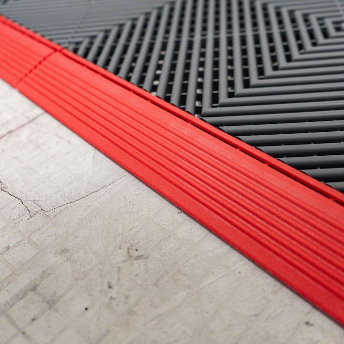 A closeup of a Racing Red ramp section and a Slate Grey tile