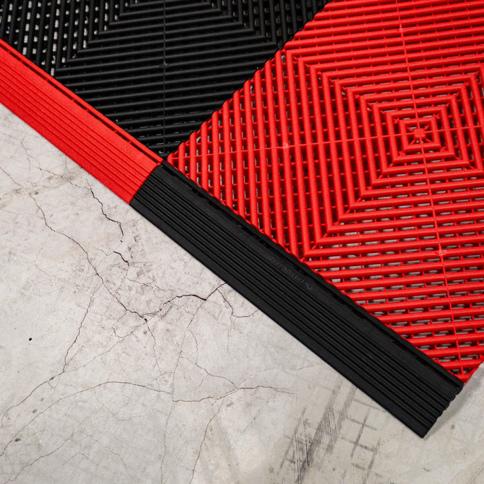 Connecting Racing Red and Jet Black Swisstrax tiles with ramp sections of opposite colours